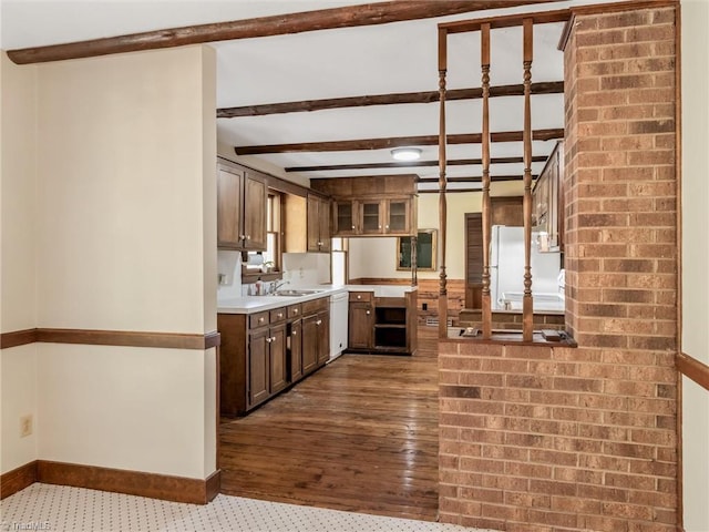 kitchen with white appliances, beam ceiling, sink, and dark hardwood / wood-style flooring