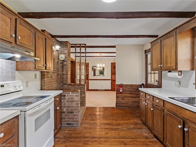 kitchen featuring sink, dark hardwood / wood-style flooring, hanging light fixtures, white electric range, and a notable chandelier