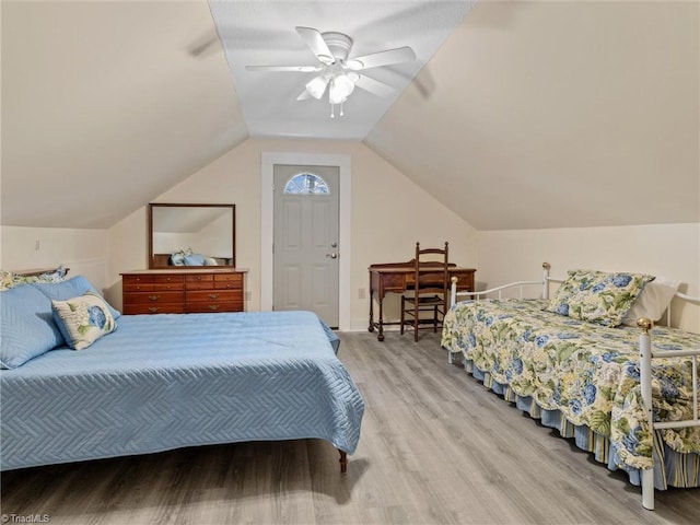 bedroom with lofted ceiling, wood-type flooring, and ceiling fan