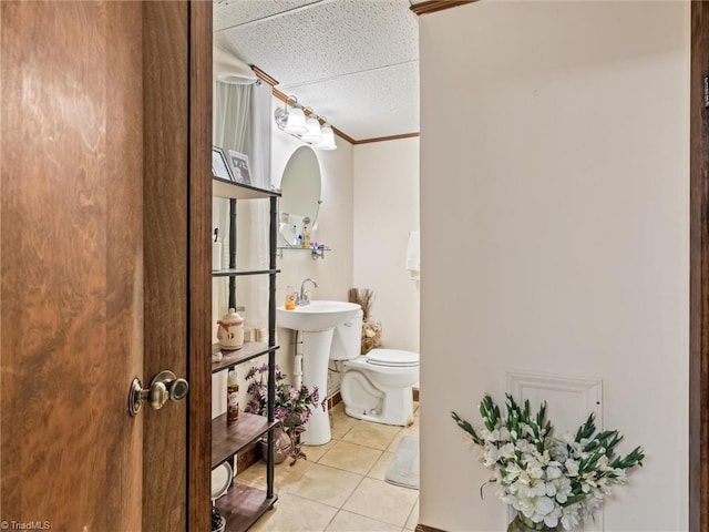 bathroom featuring ornamental molding, toilet, and tile patterned flooring