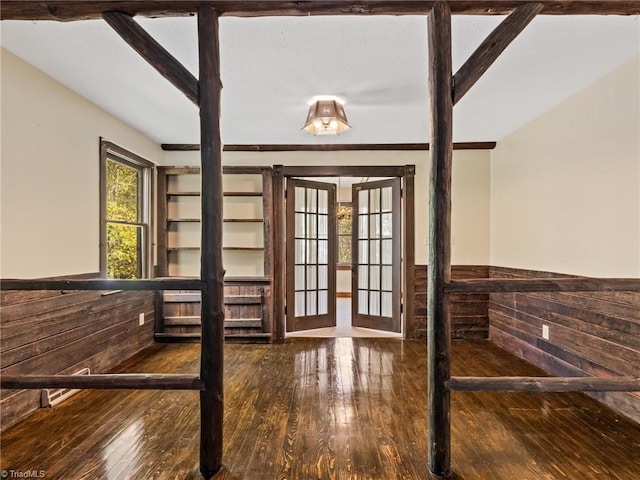 doorway with french doors and hardwood / wood-style floors