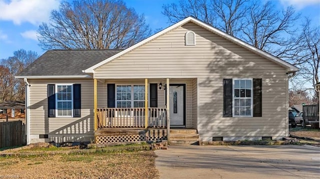 bungalow-style home featuring crawl space, a porch, and roof with shingles