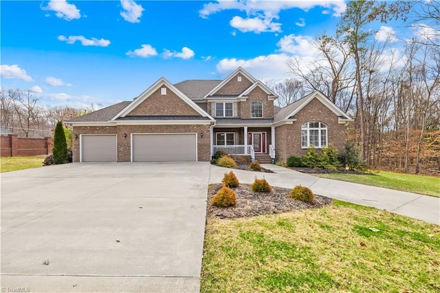 view of front of home with a front yard, concrete driveway, brick siding, and an attached garage