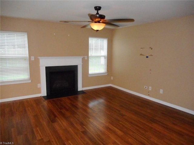 unfurnished living room featuring ceiling fan and dark hardwood / wood-style floors