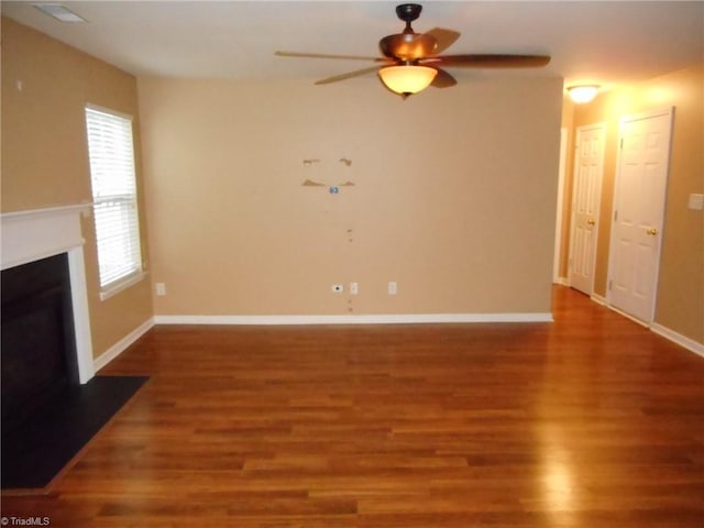 unfurnished living room with wood-type flooring and ceiling fan