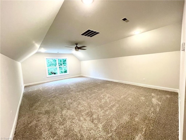 additional living space featuring carpet flooring, vaulted ceiling, and ceiling fan