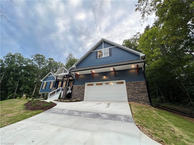 craftsman inspired home with a garage and a front yard