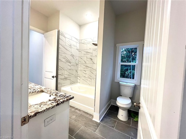 full bathroom featuring tile patterned flooring, tiled shower / bath combo, toilet, and vanity