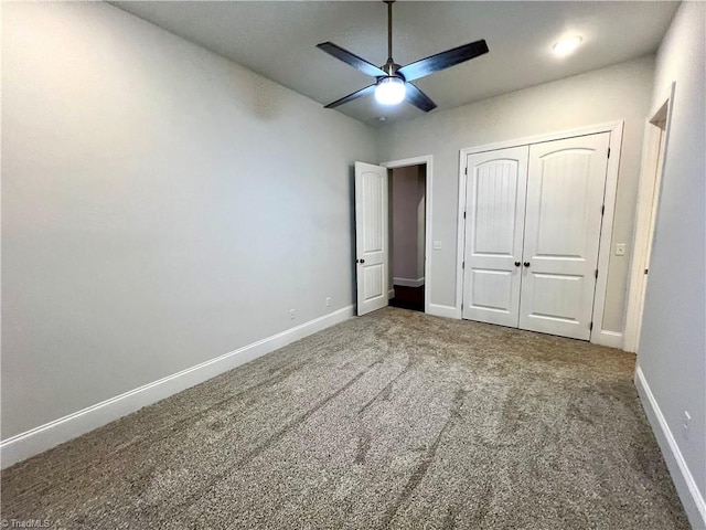 unfurnished bedroom with a closet, carpet floors, and ceiling fan