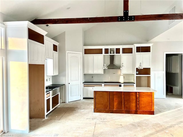 kitchen with white cabinetry, a kitchen island, beamed ceiling, wall chimney exhaust hood, and high vaulted ceiling