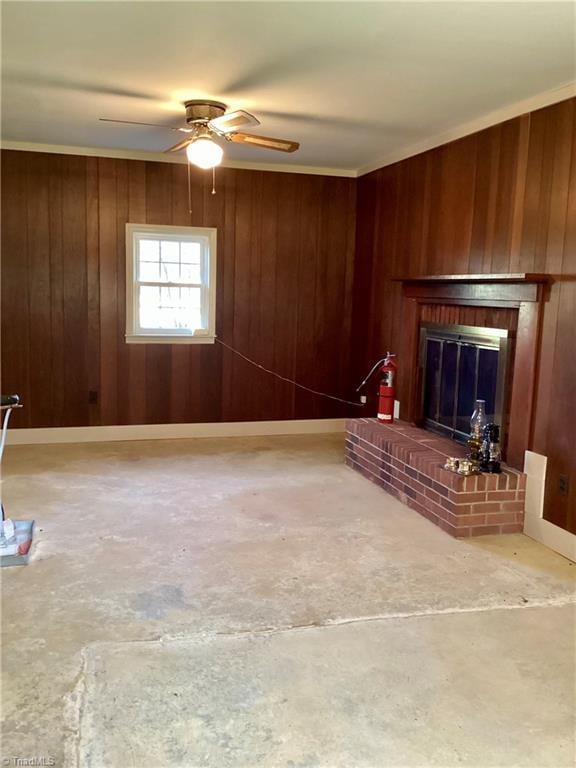 unfurnished living room featuring a fireplace, wood walls, concrete floors, and ceiling fan