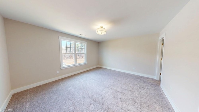 unfurnished room featuring visible vents, baseboards, and carpet