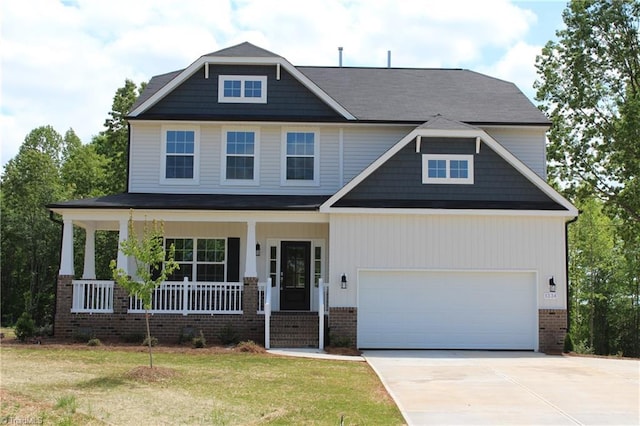 craftsman house featuring a garage, a porch, and a front yard