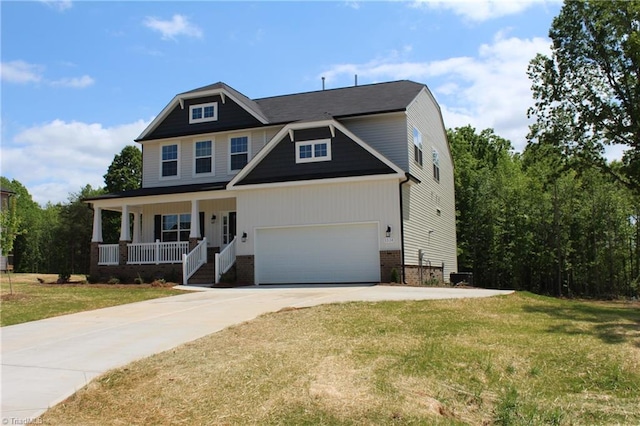 craftsman-style home featuring a front yard, a garage, and covered porch