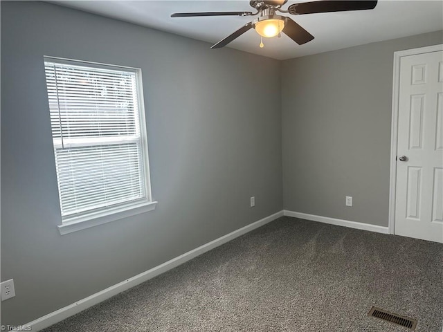 carpeted empty room featuring ceiling fan