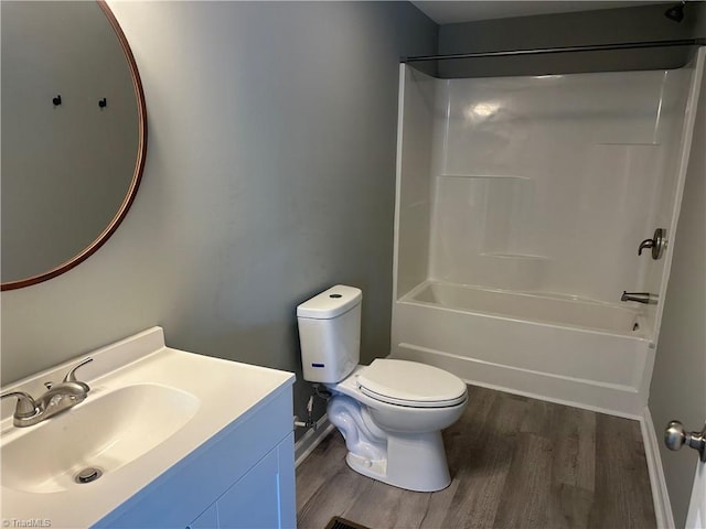 full bathroom with hardwood / wood-style floors, vanity, toilet, and washtub / shower combination