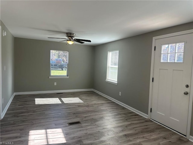 entryway with dark hardwood / wood-style flooring, ceiling fan, and a healthy amount of sunlight