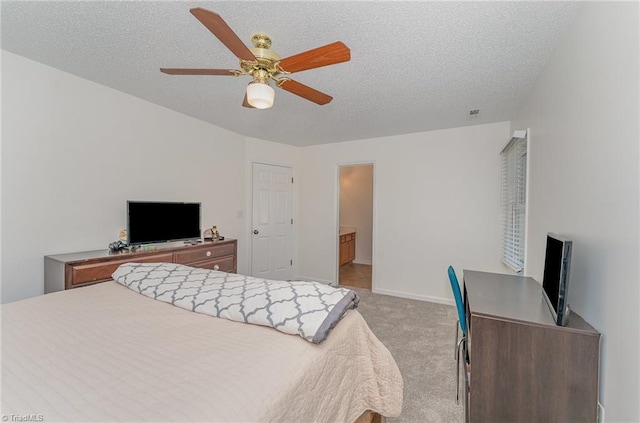 bedroom featuring light carpet, ceiling fan, a textured ceiling, and baseboards