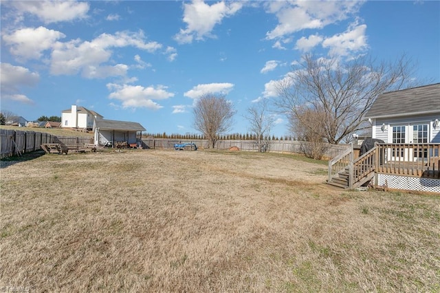 view of yard with a fenced backyard and a wooden deck