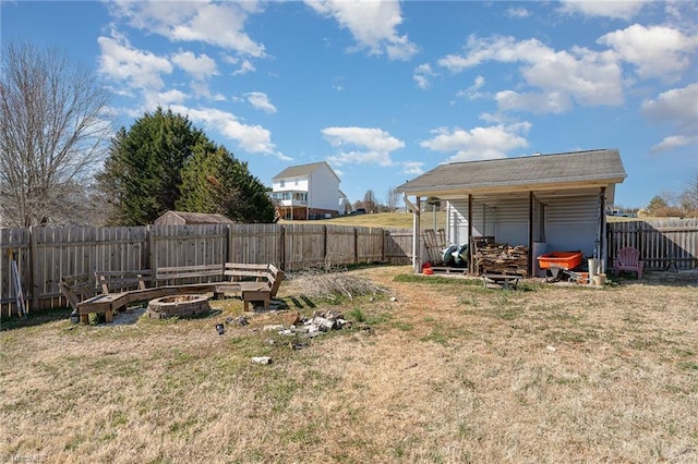 view of yard featuring an outdoor fire pit and a fenced backyard