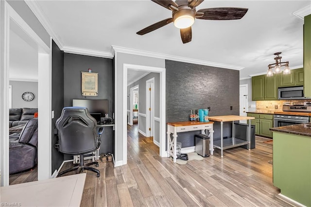 home office with crown molding, ceiling fan, and light hardwood / wood-style floors