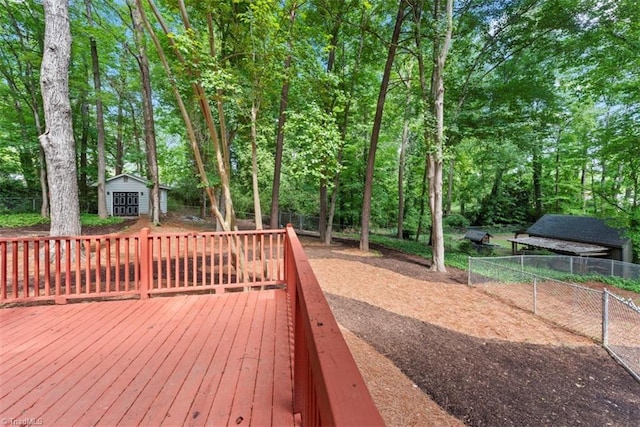 deck with an outdoor structure and fence