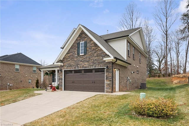 view of front of home with a garage, cooling unit, and a front lawn