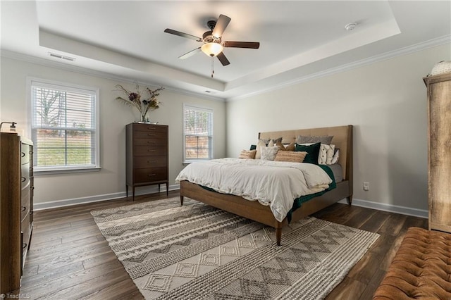 bedroom featuring a raised ceiling and dark hardwood / wood-style flooring