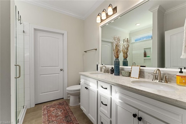 bathroom with crown molding, vanity, toilet, and a shower with shower door