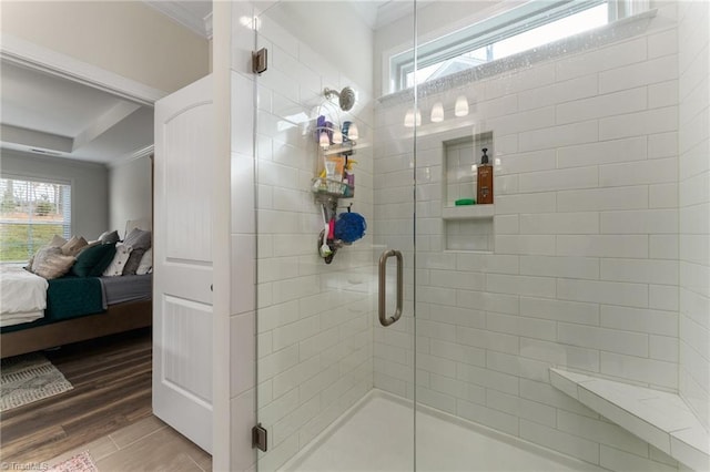 bathroom with ornamental molding, an enclosed shower, hardwood / wood-style floors, and plenty of natural light