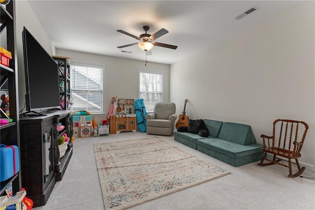 recreation room with ceiling fan and carpet