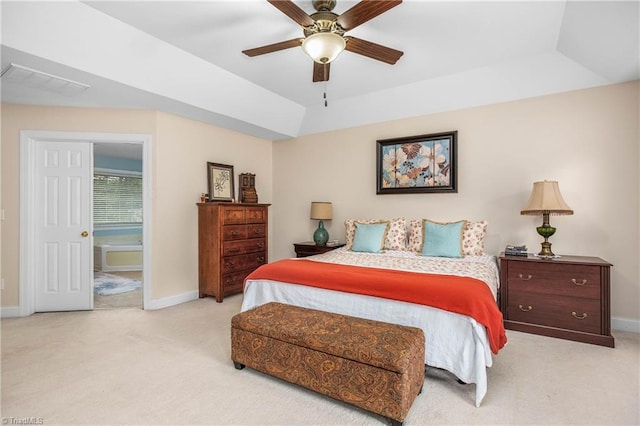 bedroom featuring baseboards, visible vents, a raised ceiling, and light colored carpet