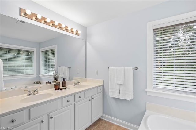 full bathroom with a garden tub, a sink, baseboards, and double vanity