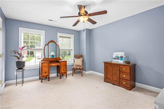 sitting room featuring baseboards, a ceiling fan, visible vents, and light colored carpet