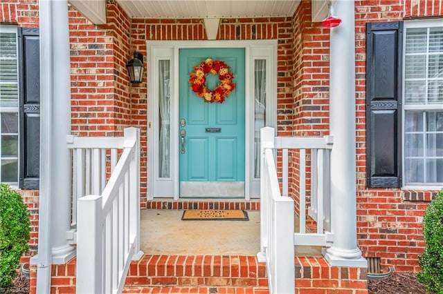 view of exterior entry with brick siding