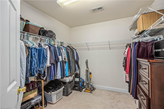 spacious closet featuring light colored carpet and visible vents