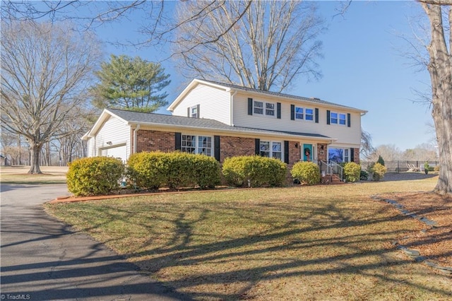 view of front facade with a front yard and a garage