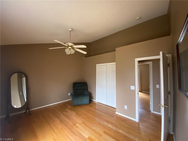 interior space featuring lofted ceiling, light hardwood / wood-style floors, and ceiling fan