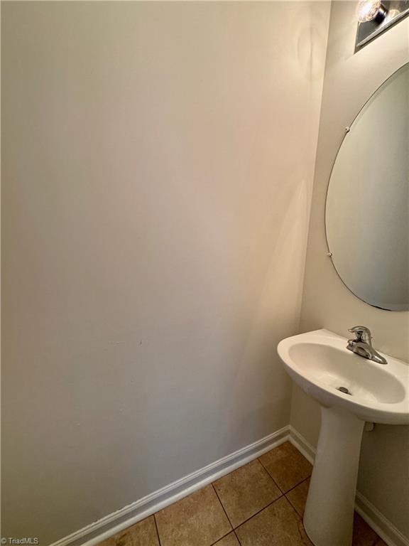 bathroom featuring tile patterned floors and baseboards