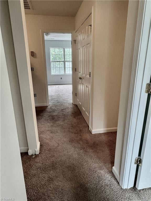 hall with carpet and baseboards
