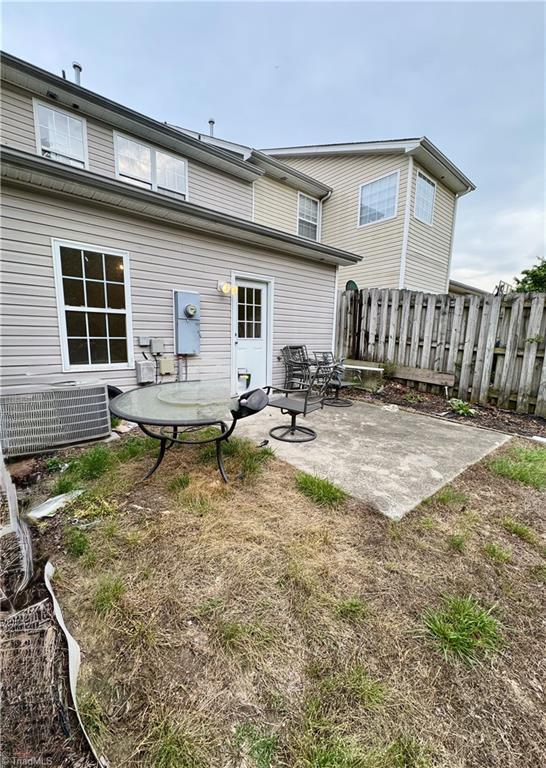 back of property with a patio, fence, and central AC unit