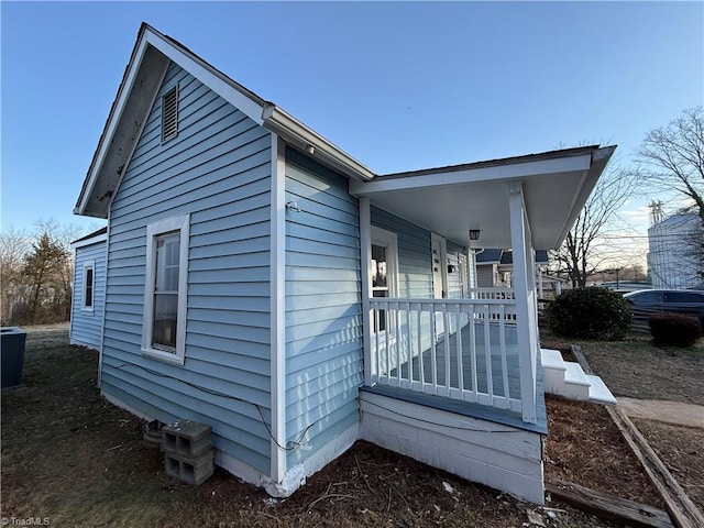 view of side of home featuring a porch