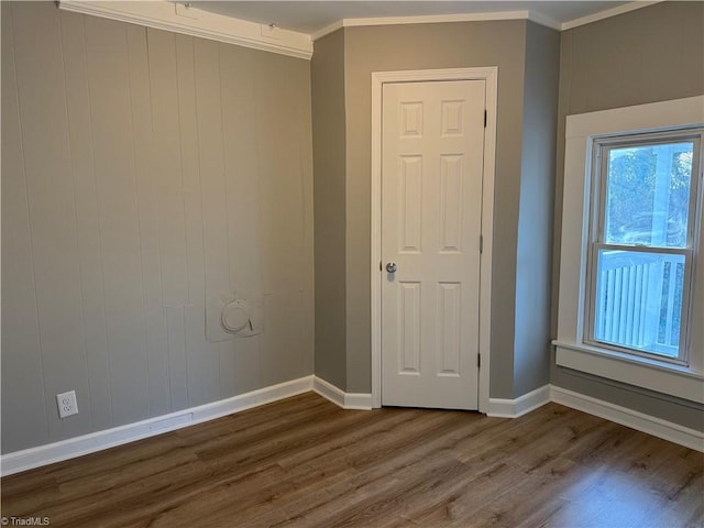 spare room featuring crown molding and dark hardwood / wood-style floors