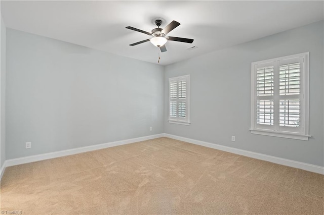 spare room featuring ceiling fan and light carpet