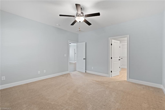 unfurnished bedroom with light colored carpet and ceiling fan