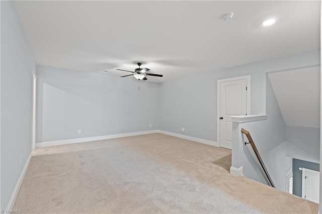 carpeted spare room with ceiling fan and vaulted ceiling