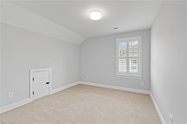 additional living space featuring carpet flooring and lofted ceiling