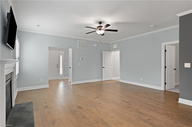 unfurnished living room featuring hardwood / wood-style flooring, ceiling fan, and crown molding