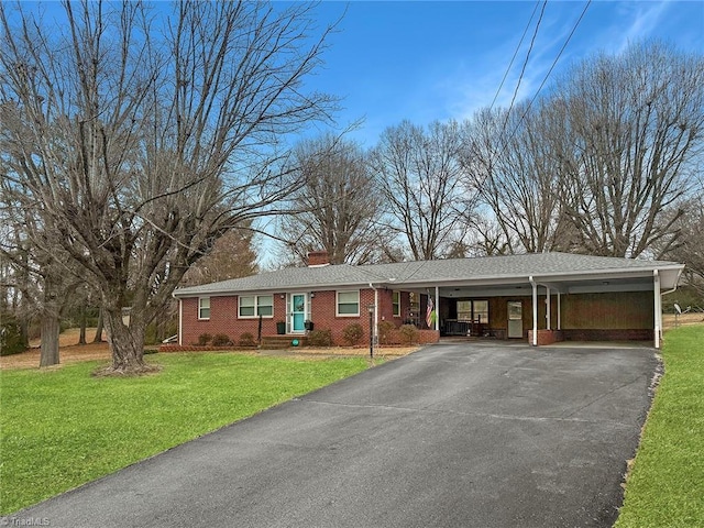 single story home with a front lawn and a carport