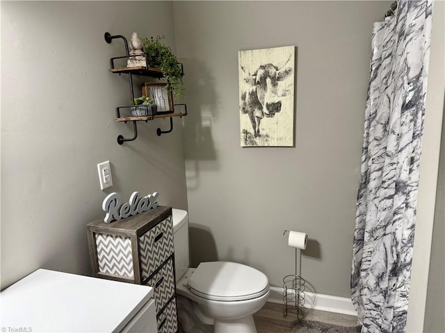 bathroom featuring hardwood / wood-style floors and toilet